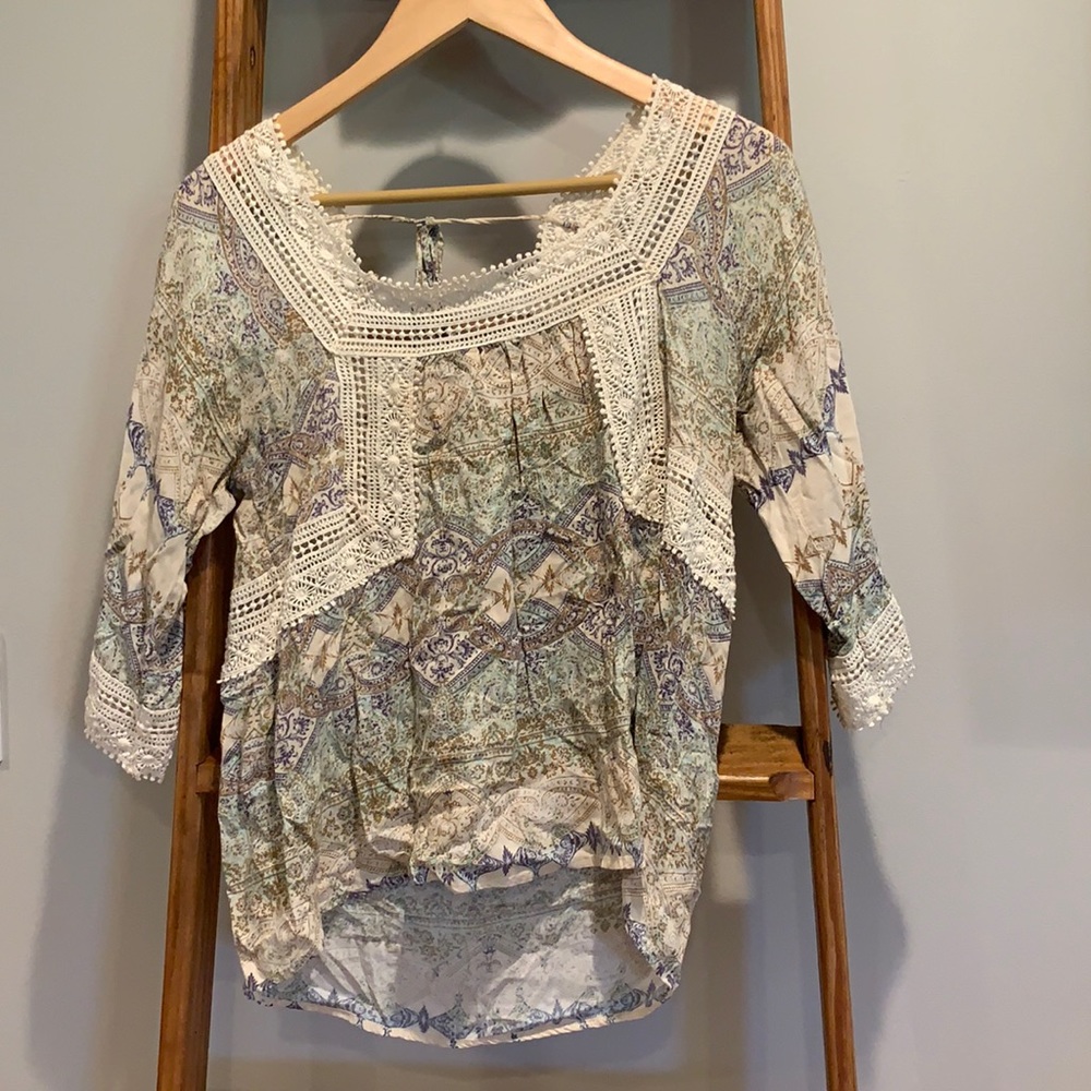 Flowy white, blue, light blue, and tan blouse.